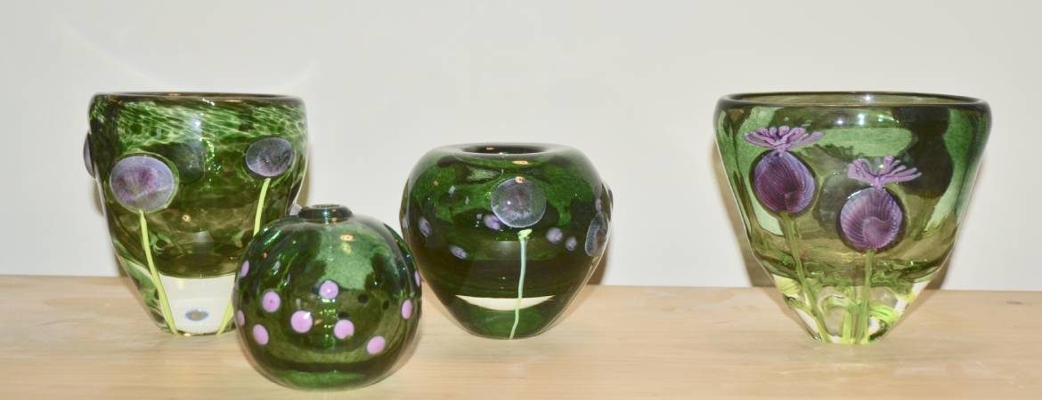 Selection of green Siddy Langley vases depicting alliums in the garden