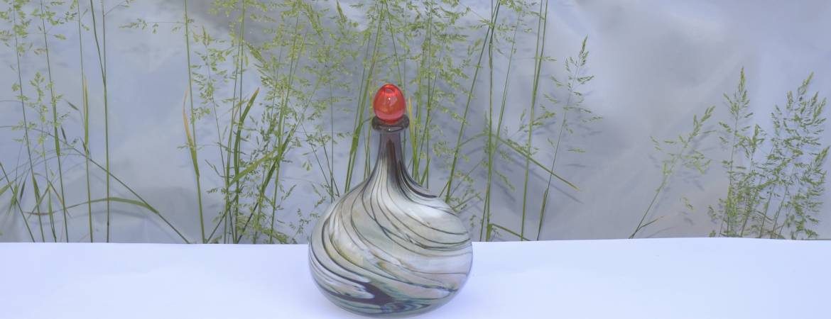 Siddy Langley Cream and Red stoppered Oval Flask in front of grasses